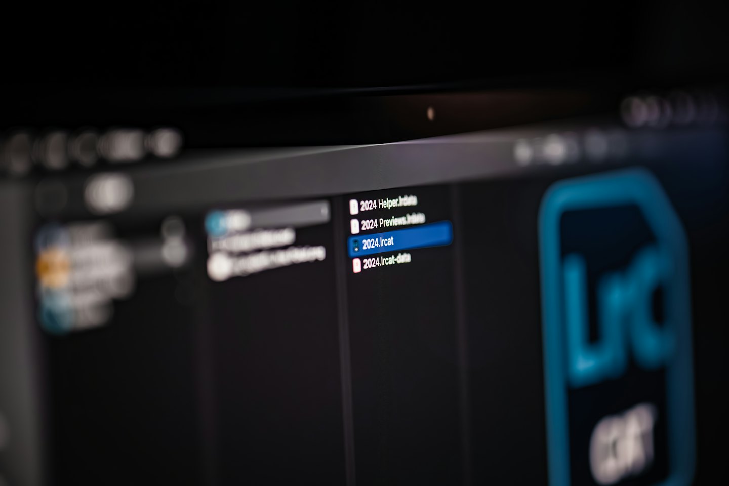 Laptop screen shows file directory with photo management software.